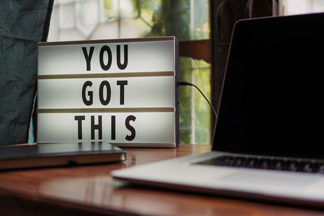 Image of a laptop on a desk with a focused light box saying 'You Got This'