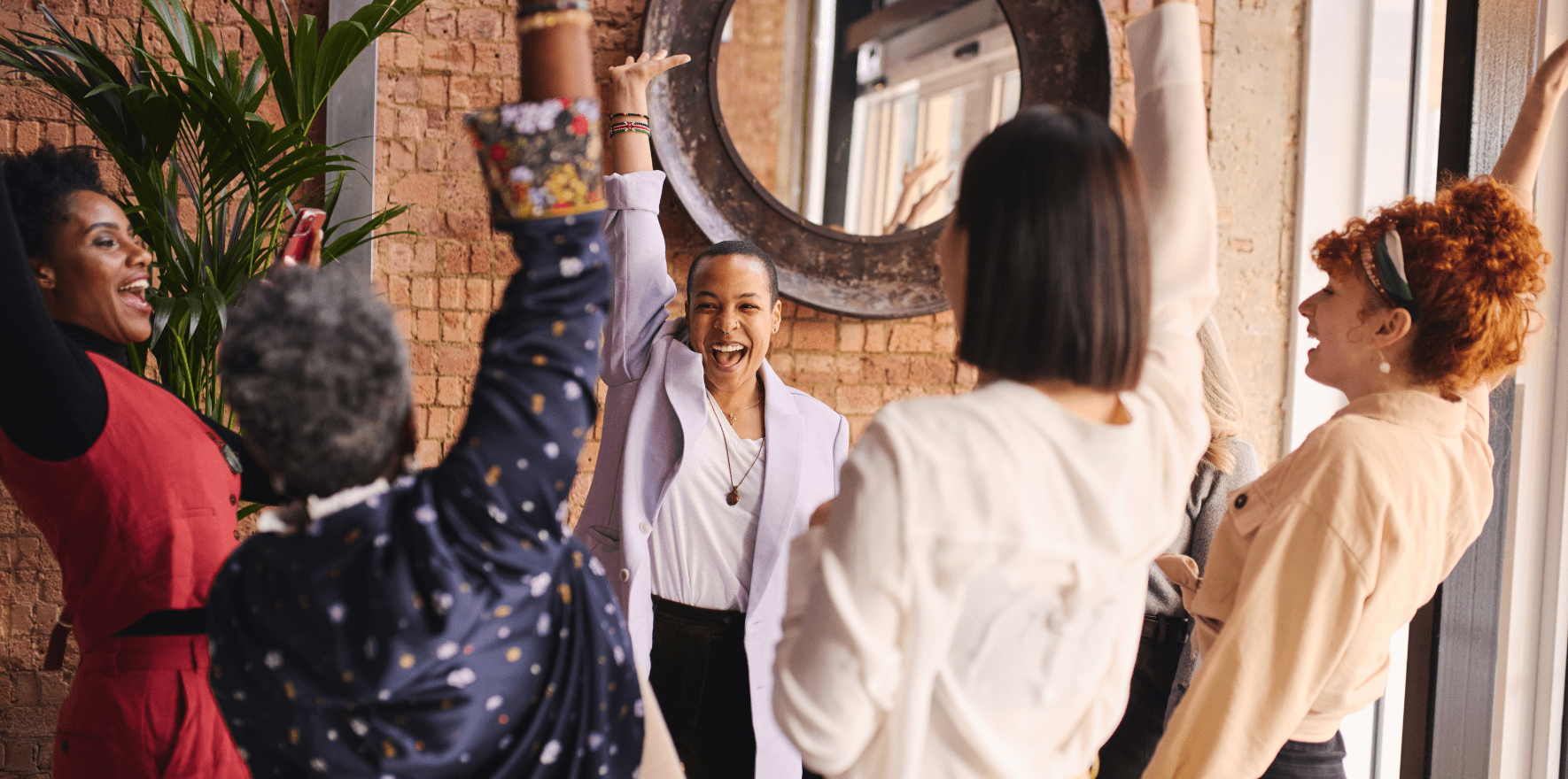 group of 5 diverse work colleagues celebrating