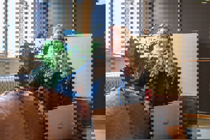 businesswoman sat smiling whilst making a phone call