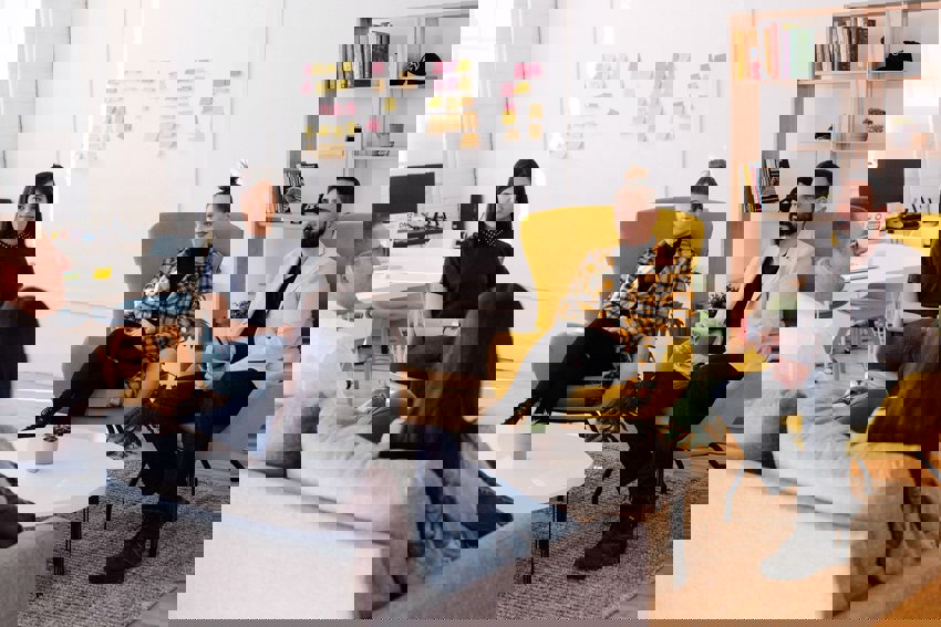 A group of people having a meeting in a casual setting