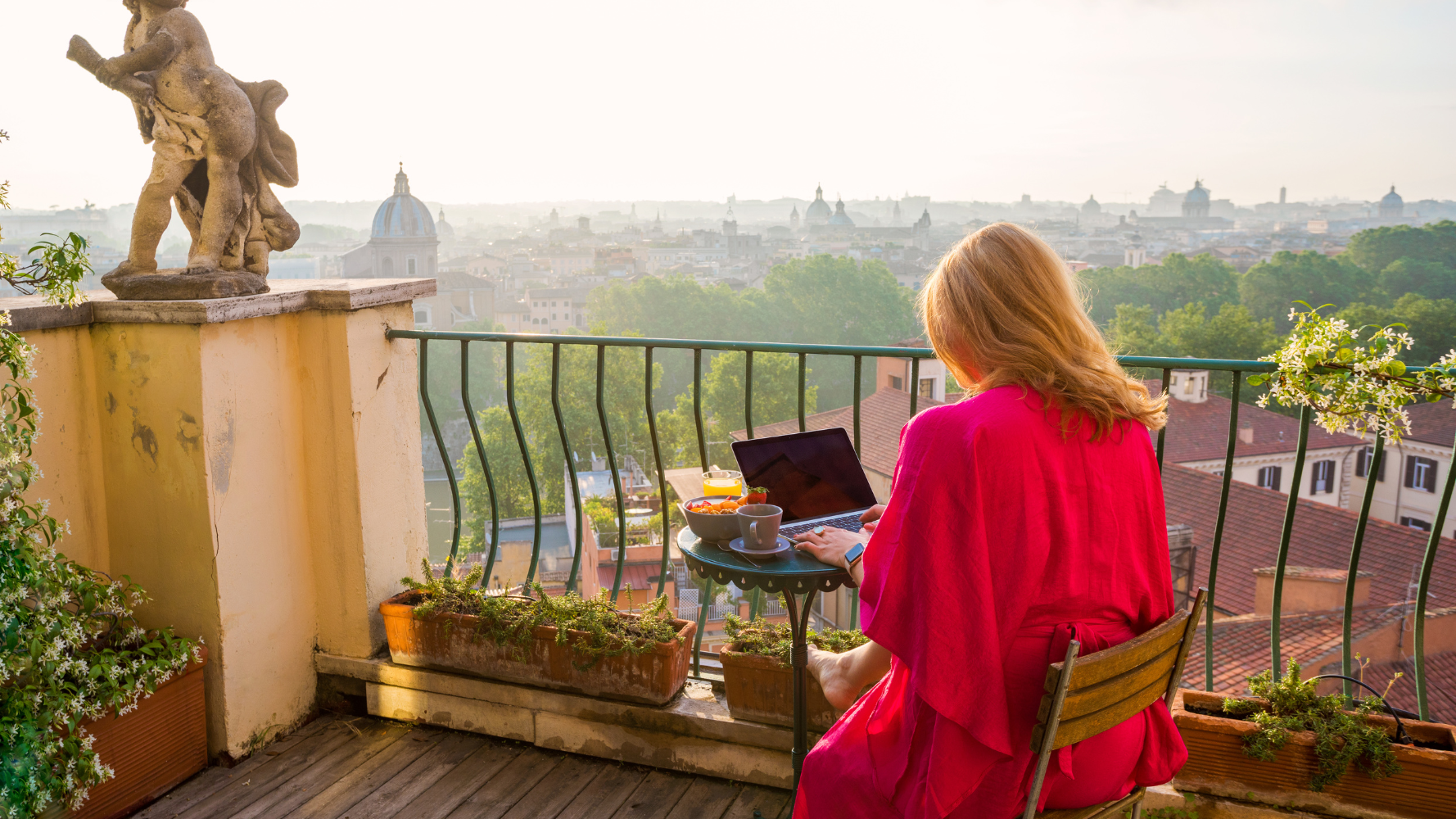 woman working abroad on balcony through company work from home policy
