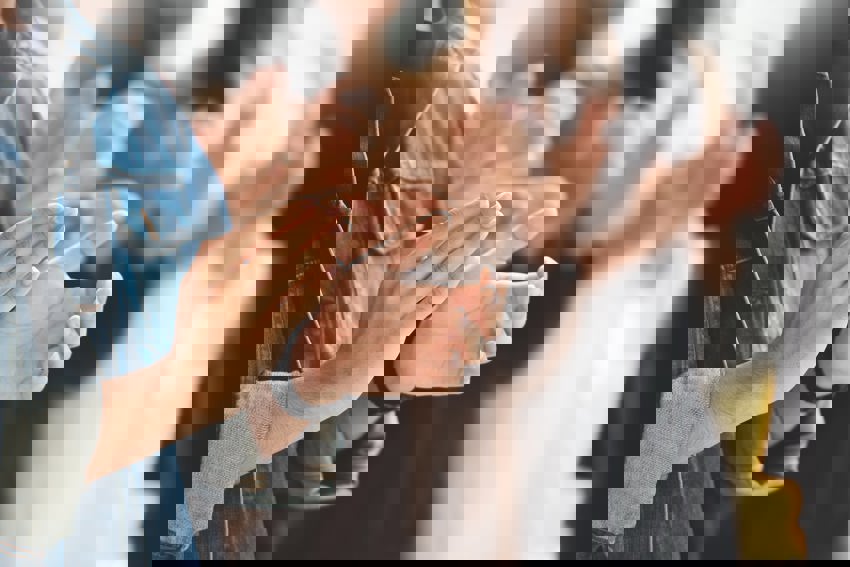 Close up picture of a group of people clapping.