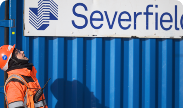 On-site worker stands outside Severfield branded crate