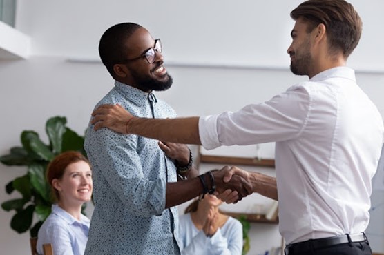 A congratulatory handshake in the workplace